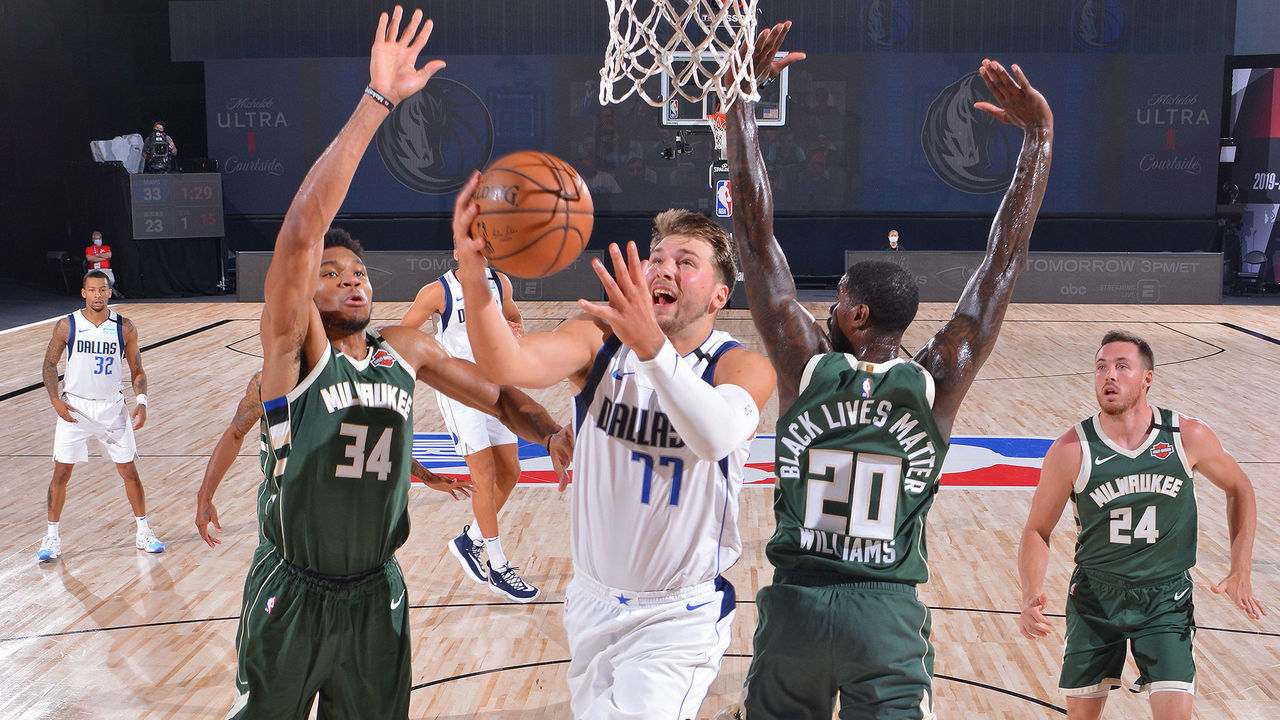 ORLANDO, FL - AUGUST 08: Luka Doncic #77 of the Dallas Mavericks drives to the basket against the Milwaukee Bucks on August 8, 2020 in Orlando, Florida at AdventHealth Arena. NOTE TO USER: User expressly acknowledges and agrees that, by downloading and/or using this photograph, user is consenting to the terms and conditions of the Getty Images License Agreement. Mandatory Copyright Notice: Copyright 2020 NBAE