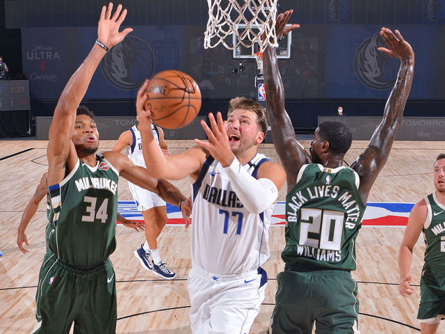 ORLANDO, FL - AUGUST 08: Luka Doncic #77 of the Dallas Mavericks drives to the basket against the Milwaukee Bucks on August 8, 2020 in Orlando, Florida at AdventHealth Arena. NOTE TO USER: User expressly acknowledges and agrees that, by downloading and/or using this photograph, user is consenting to the terms and conditions of the Getty Images License Agreement. Mandatory Copyright Notice: Copyright 2020 NBAE