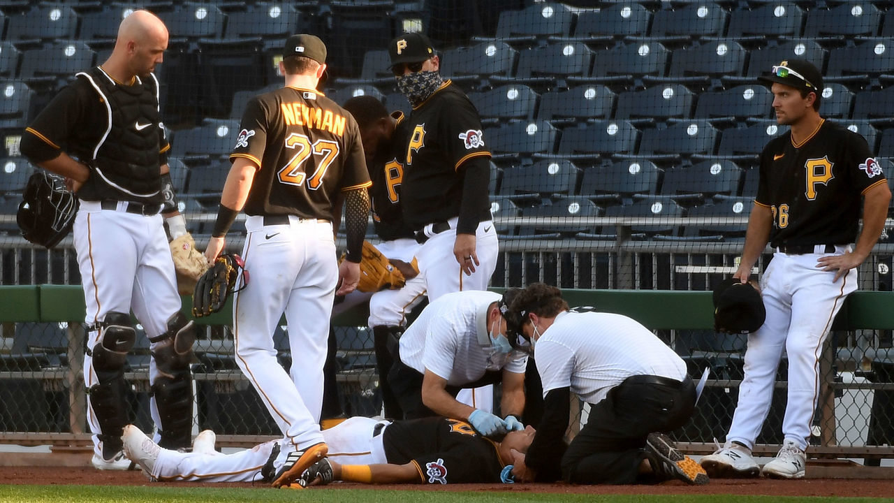 PITTSBURGH, PA - AUGUST 08: Phillip Evans #64 of the Pittsburgh Pirates is tended to by Pirates trainers after a collision with teammate Gregory Polanco #25 in the sixth inning during the game against the Detroit Tigers at PNC Park on August 8, 2020 in Pittsburgh, Pennsylvania.