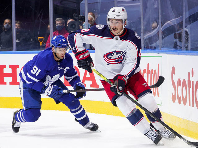 TORONTO, ONTARIO - AUGUST 04: Zach Werenski #8 of the Columbus Blue Jackets plays the puck against John Tavares #91 of the Toronto Maple Leafs during the first period in Game Two of the Eastern Conference Qualification Round at Scotiabank Arena on August 04, 2020 in Toronto, Ontario.