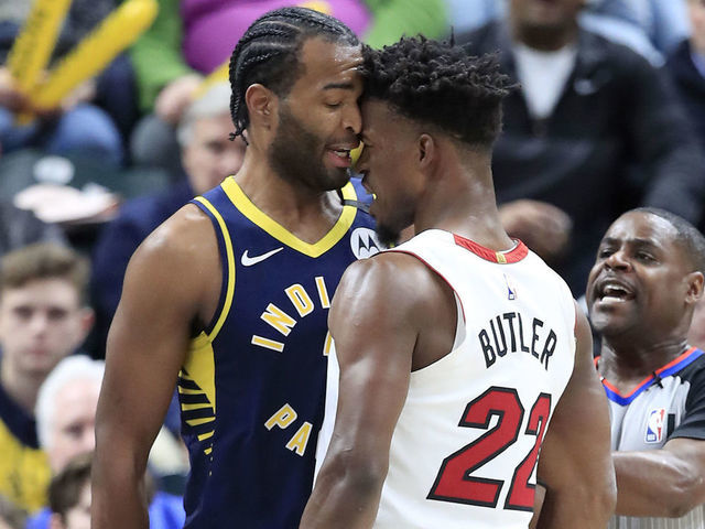 INDIANAPOLIS, INDIANA - JANUARY 08: Jimmy Butler #22 of the Miami Heat and T.J. Warren #1 of the Indiana Pacers get involved in an argument during the game at Bankers Life Fieldhouse on January 08, 2020 in Indianapolis, Indiana.