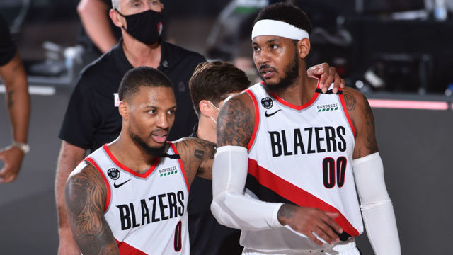 Orlando, FL - AUGUST 9: Damian Lillard #0 of the Portland Trail Blazers and Carmelo Anthony #00 of the Portland Trail Blazers talk after a game against the Philadelphia 76ers on August 9, 2020 at Visa Athletic Center at ESPN Wide World of Sports in Orlando, Florida. NOTE TO USER: User expressly acknowledges and agrees that, by downloading and/or using this Photograph, user is consenting to the terms and conditions of the Getty Images License Agreement. Mandatory Copyright Notice: Copyright 2020 NBAE