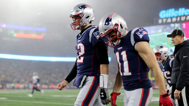 FOXBOROUGH, MASSACHUSETTS - JANUARY 04: Tom Brady #12 of the New England Patriots and Julian Edelman #11 together on the sideline during the the AFC Wild Card Playoff game against the Tennessee Titans at Gillette Stadium on January 04, 2020 in Foxborough, Massachusetts.