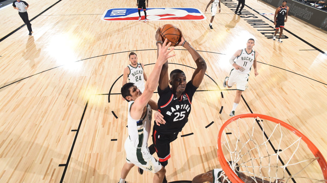 Orlando, FL - AUGUST 10: Chris Boucher #25 of the Toronto Raptors dunks the ball against the Milwaukee Bucks on August 10, 2020 at The Field House at ESPN Wide World Of Sports Complex in Orlando, Florida. NOTE TO USER: User expressly acknowledges and agrees that, by downloading and/or using this Photograph, user is consenting to the terms and conditions of the Getty Images License Agreement. Mandatory Copyright Notice: Copyright 2020 NBAE