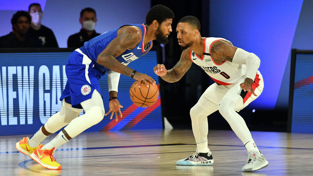 Orlando, FL - AUGUST 8: Paul George #13 of the LA Clippers handles the ball while Damian Lillard #0 of the Portland Trail Blazers plays defense during the game on August 8, 2020 at The Field House at ESPN Wide World Of Sports Complex in Orlando, Florida. NOTE TO USER: User expressly acknowledges and agrees that, by downloading and/or using this Photograph, user is consenting to the terms and conditions of the Getty Images License Agreement. Mandatory Copyright Notice: Copyright 2020 NBAE