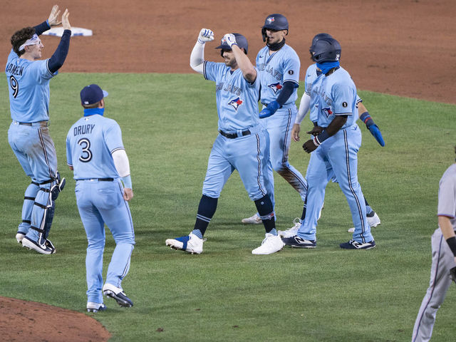 BUFFALO, NY - AUGUST 11: Toronto Blue Jays Third Baseman Travis Shaw (6) celebrates his game winning hit with his teammates during the tenth inning of the Major League Baseball game between the Miami Marlins and the Toronto Blue Jays on August 11, 2020, at Sahlen Field in Buffalo, NY.