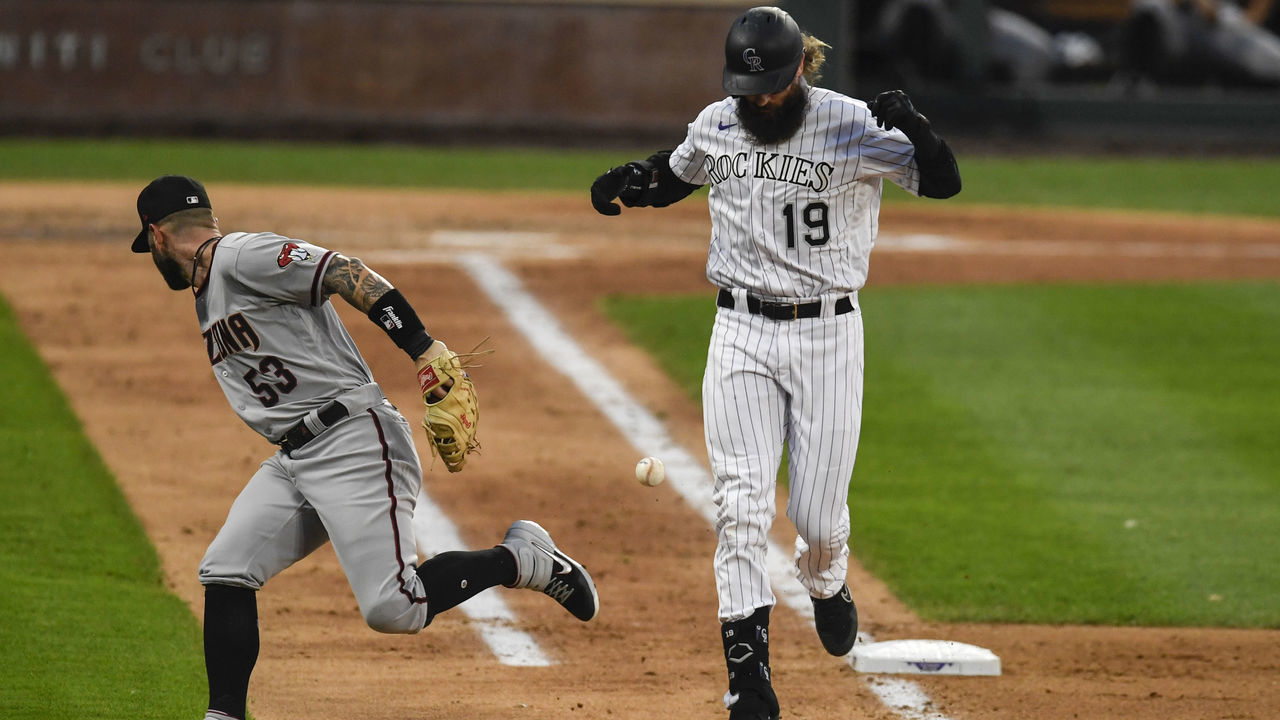DENVER, CO - AUGUST 11: Christian Walker (53) of the Arizona Diamondbacks cannot handle the throw from Ketel Marte (4) as Charlie Blackmon (19) of the Colorado Rockies reaches first base safely at Coors Field on Tuesday, August 11, 2020.