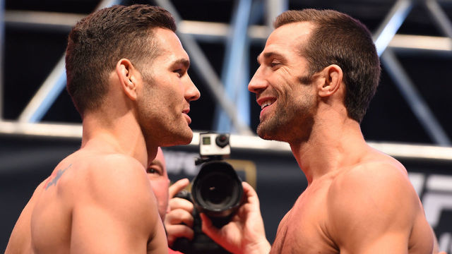 LAS VEGAS, NV - DECEMBER 11: (L-R) UFC middleweight champion Chris Weidman and challenger Luke Rockhold face off during the UFC 194 weigh-in inside MGM Grand Garden Arena on December 10, 2015 in Las Vegas, Nevada.