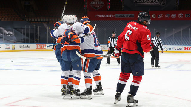 TORONTO, ONTARIO - AUGUST 12: Josh Bailey #12, Anthony Beauvillier #18 and Mathew Barzal #13 of the New York Islanders celebrate after Beauvillier scored a goal as Michal Kempny #6 of the Washington Capitals skates to the bench in the third period of Game One of the Eastern Conference First Round of the 2020 NHL Stanley Cup Playoff at Scotiabank Arena on August 12, 2020 in Toronto, Ontario. Lee scored on the play.