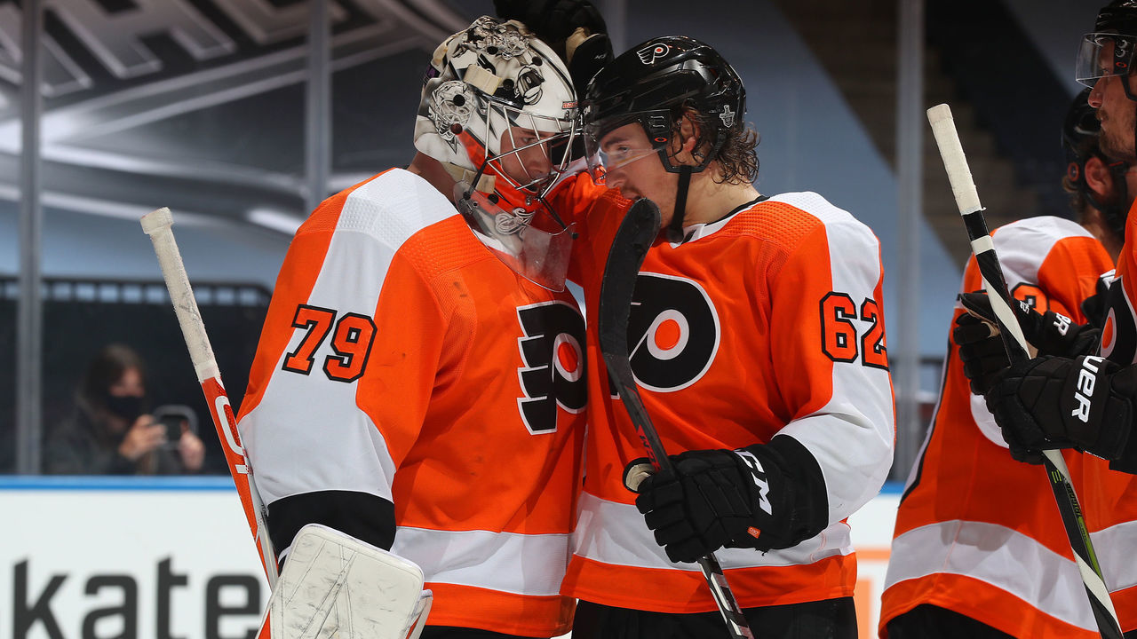TORONTO, ONTARIO - AUGUST 12: Goaltender Carter Hart #79 of the Philadelphia Flyers is congratulated by teammate Nicolas Aube-Kubel #62 after Game One of the Eastern Conference First Round of the 2020 NHL Stanley Cup Playoff against the Montreal Canadiens at Scotiabank Arena on August 12, 2020 in Toronto, Ontario.