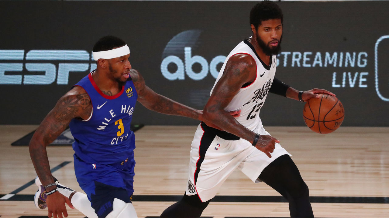 LAKE BUENA VISTA, FLORIDA - AUGUST 12: Paul George #13 of the LA Clippers controls the ball Torrey Craig #3 of the Denver Nuggets in the second quarter at AdventHealth Arena at ESPN Wide World Of Sports Complex on August 12, 2020 in Lake Buena Vista, Florida.