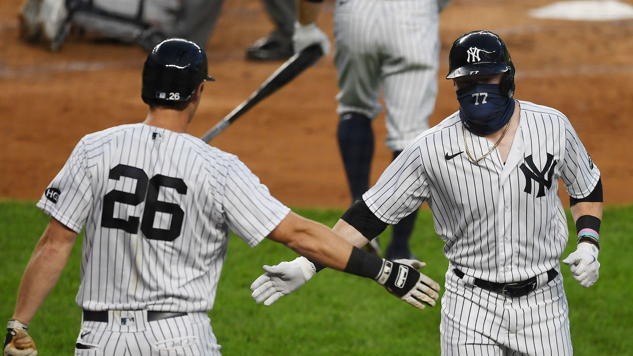 NEW YORK, NEW YORK - AUGUST 12: Clint Frazier #77 of the New York Yankees slaps gloved hands with DJ LeMahieu #26 after Frazier's home run in the second inning against the Atlanta Braves at Yankee Stadium on August 12, 2020 in the Bronx borough of New York City.