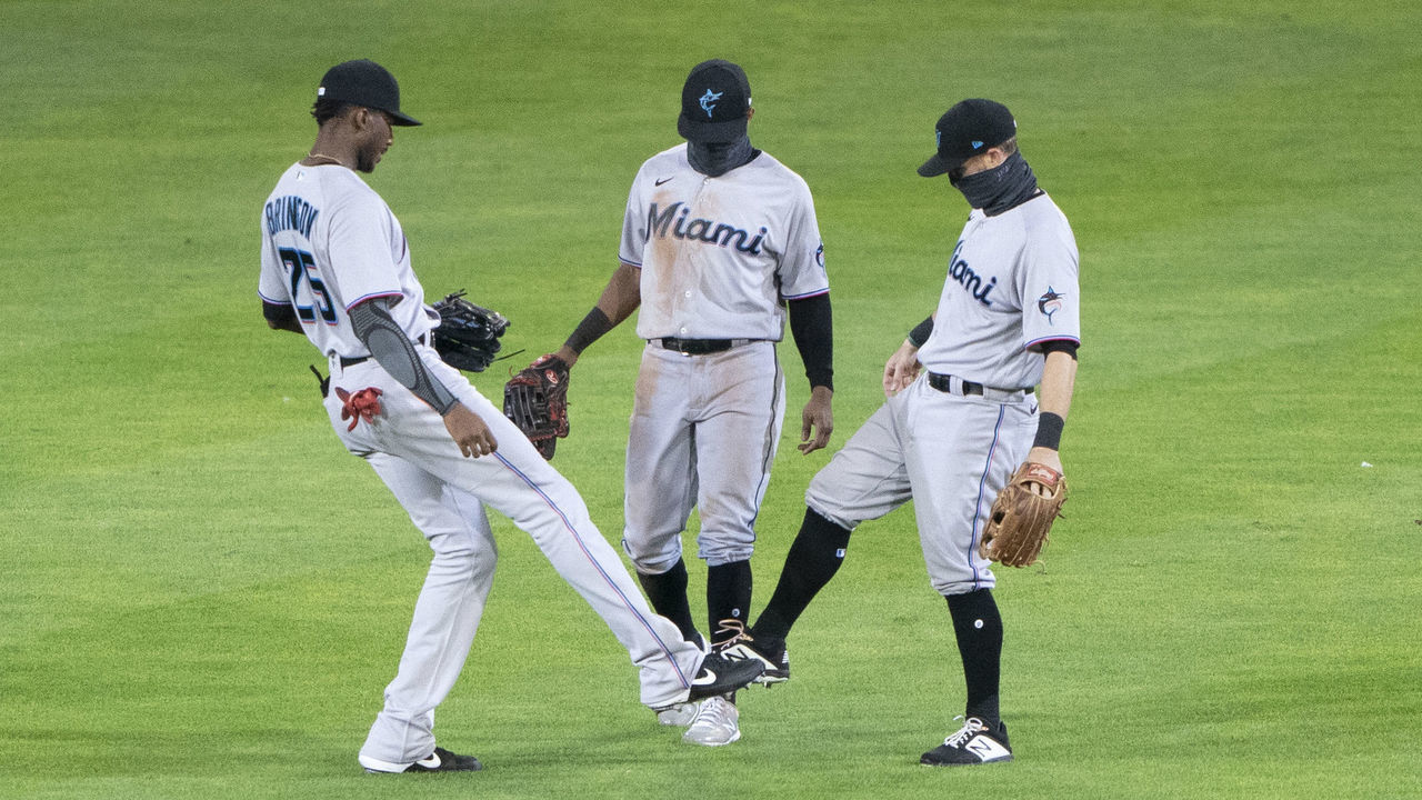 BUFFALO, NY - AUGUST 12: Miami Marlins Right Fielder Lewis Brinson (25) and Miami Marlins Center Fielder Magneuris Sierra (34) and Miami Marlins Second Baseman Jon Berti (5) tap foots to celebrate the victory after the tenth inning of the Major League Baseball game between the Miami Marlins and the Toronto Blue Jays on August 12, 2020, at Sahlen Field in Buffalo, NY.