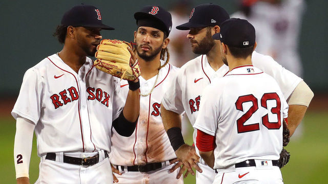 BOSTON, MASSACHUSETTS - AUGUST 11: Xander Bogaerts #2, Jonathan Arauz #36, Mitch Moreland #18 and Michael Chavis #23 of the Boston Red Sox talk during the eighth inning of the game against the Tampa Bay Rays at Fenway Park on August 11, 2020 in Boston, Massachusetts. The Rays defeat the Red Sox 8-2.