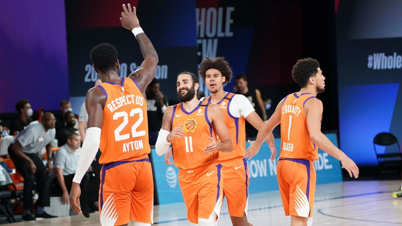 ORLANDO, FL - AUGUST 13: Deandre Ayton #22 high-fives Ricky Rubio #11 of the Phoenix Suns during the game on August 13, 2020 at AdventHealth Arena in Orlando, Florida. NOTE TO USER: User expressly acknowledges and agrees that, by downloading and/or using this Photograph, user is consenting to the terms and conditions of the Getty Images License Agreement. Mandatory Copyright Notice: Copyright 2020 NBAE