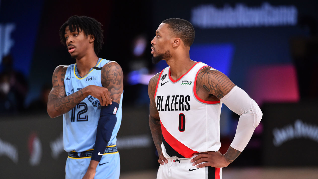 Orlando, FL - JULY 31: Ja Morant #12 of the Memphis Grizzlies and Damian Lillard #0 of the Portland Trail Blazers look on during a game on July 31, 2020 at The Arena at ESPN Wide World Of Sports Complex in Orlando, Florida. NOTE TO USER: User expressly acknowledges and agrees that, by downloading and/or using this Photograph, user is consenting to the terms and conditions of the Getty Images License Agreement. Mandatory Copyright Notice: Copyright 2020 NBAE