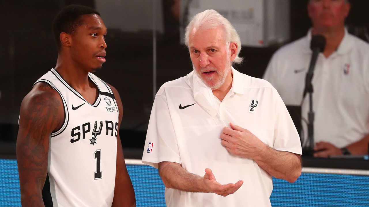 LAKE BUENA VISTA, FLORIDA - AUGUST 05: Lonnie Walker IV #1 of the San Antonio Spurs talks with head coach Gregg Popovich during the second half at Visa Athletic Center at ESPN Wide World Of Sports Complex on August 5, 2020 in Lake Buena Vista, Florida.
