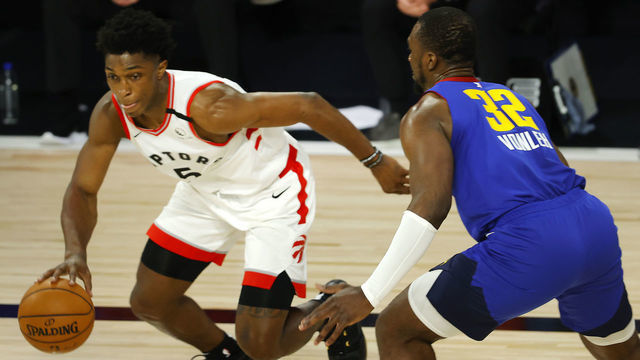 LAKE BUENA VISTA, FLORIDA - AUGUST 14: Stanley Johnson #5 of the Toronto Raptors drives the ball against Noah Vonleh #32 of the Denver Nuggets during the fourth quarter at The Field House at ESPN Wide World Of Sports Complex on August 14, 2020 in Lake Buena Vista, Florida.