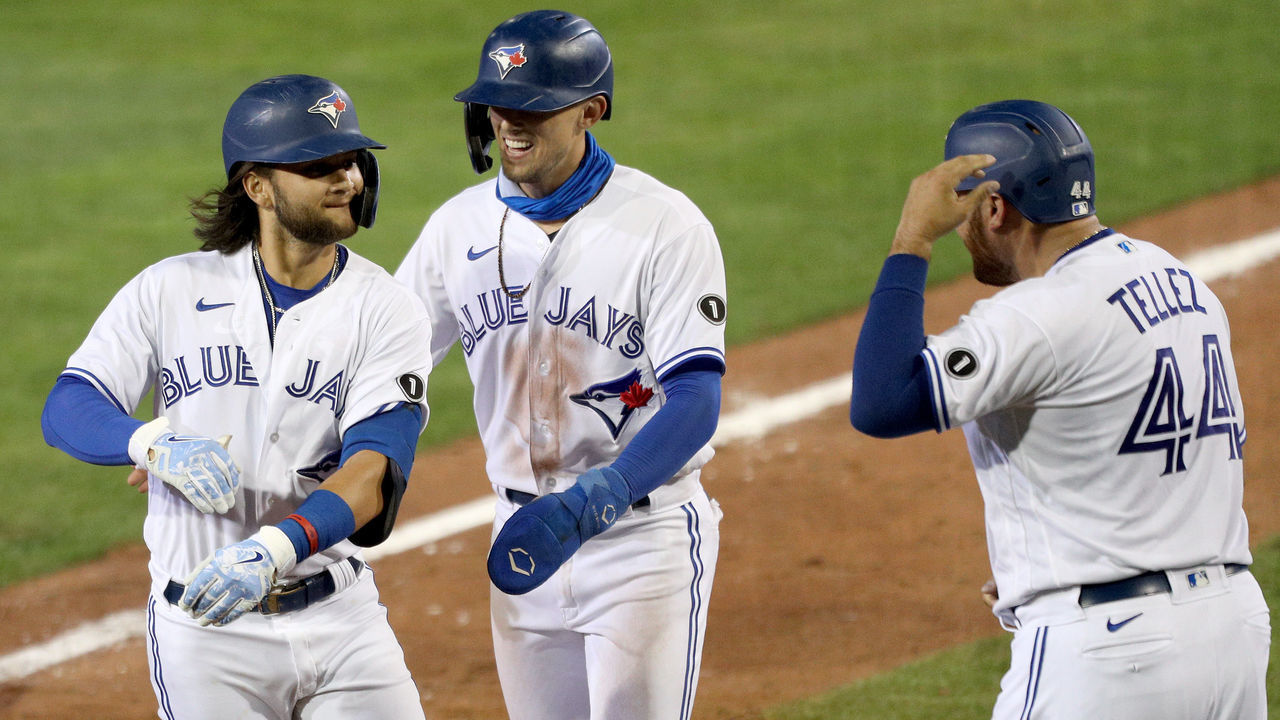 BUFFALO, NEW YORK - AUGUST 14: Bo Bichette #11 of the Toronto Blue Jays celebrates with teammates Cavan Biggio #8 and Rowdy Tellez #44 after hitting a three run home run during the sixth inning of an MLB game against the Tampa Bay Rays at Sahlen Field on August 14, 2020 in Buffalo, New York. The Blue Jays are the home team and are playing their home games in Buffalo due to the Canadian government’s policy on coronavirus (COVID-19).