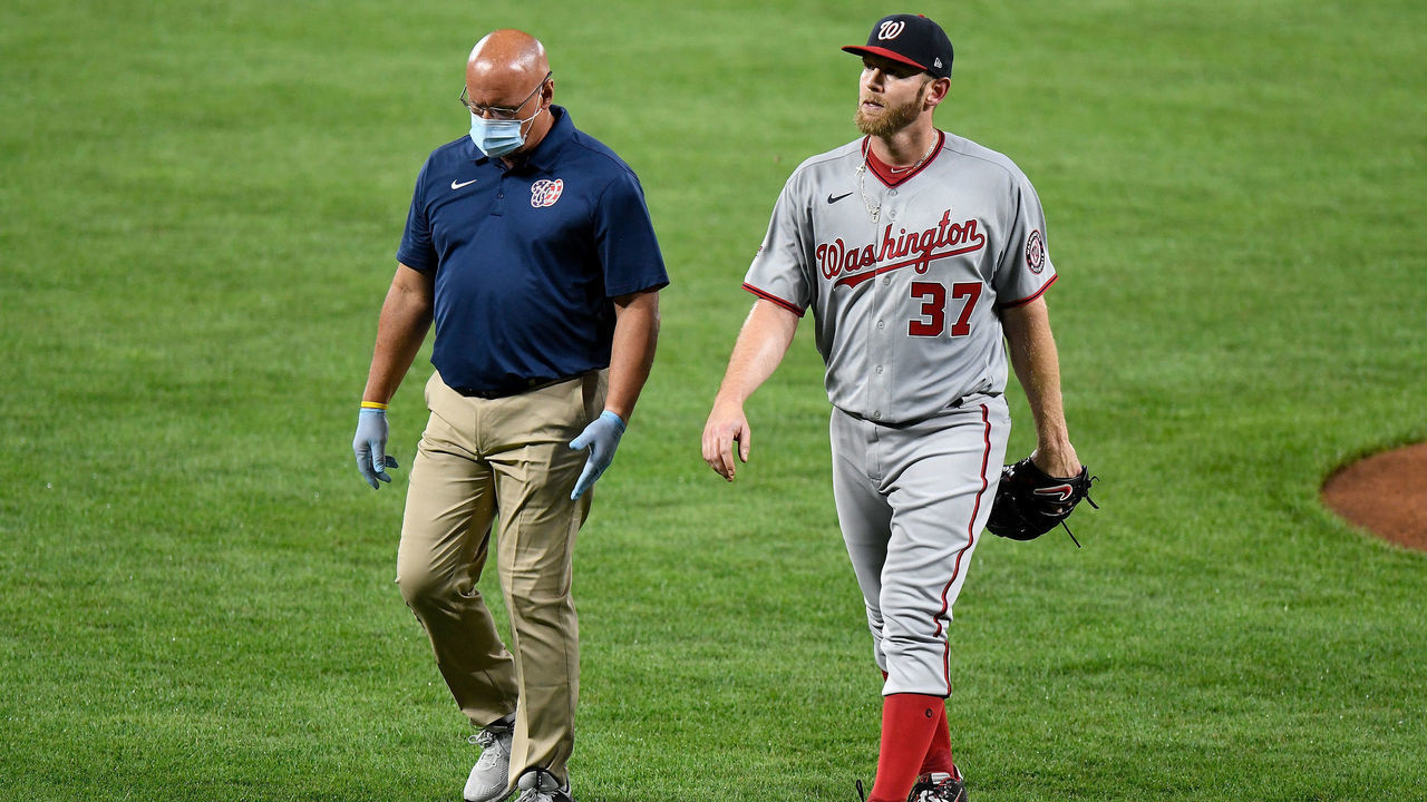 BALTIMORE, MD - AUGUST 14: Stephen Strasburg #37 of the Washington Nationals walks off the field with trainer Paul Lessard after coming out of the game in the first inning against the Baltimore Orioles at Oriole Park at Camden Yards on August 14, 2020 in Baltimore, Maryland.