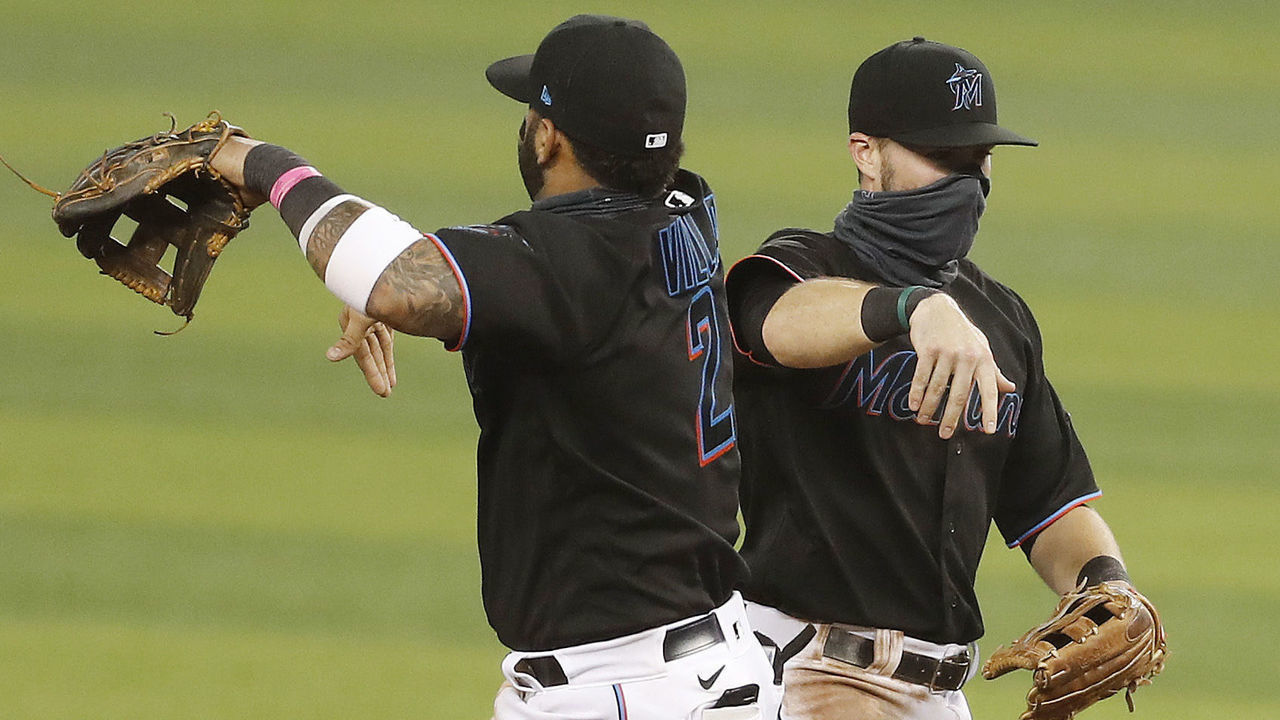 MIAMI, FLORIDA - AUGUST 14: Jon Berti #5 and Jonathan Villar #2 of the Miami Marlins celebrate after defeating the Atlanta Braves 8-2 at Marlins Park on August 14, 2020 in Miami, Florida.
