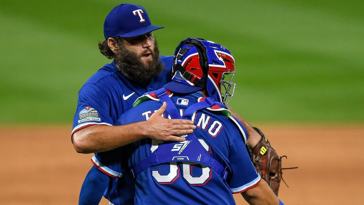 DENVER, CO - AUGUST 14: Lance Lynn #35 of the Texas Rangers hugs Jose Trevino #56 of the Texas Rangers after the final out of his complete game against the Colorado Rockies celebrate the final out of his complete game against the Colorado Rockies at Coors Field on August 14, 2020 in Denver, Colorado.