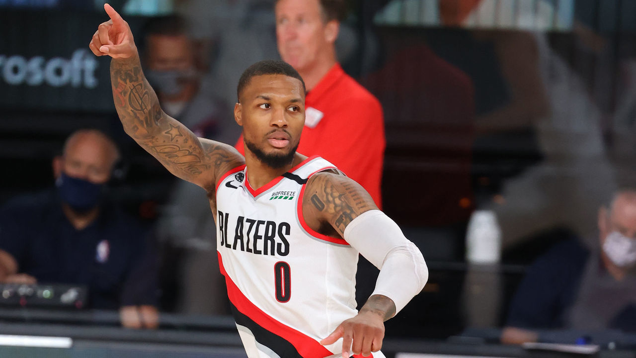 ORLANDO, FL - AUGUST 13: Damian Lillard #0 of the Portland Trail Blazers points and runs up court against the Brooklyn Nets on August 13, 2020 in Orlando, Florida at AdventHealth Arena at ESPN Wide World of Sports. NOTE TO USER: User expressly acknowledges and agrees that, by downloading and/or using this photograph, user is consenting to the terms and conditions of the Getty Images License Agreement. Mandatory Copyright Notice: Copyright 2020 NBAE