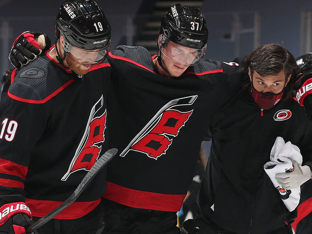TORONTO, ONTARIO - AUGUST 15: Andrei Svechnikov #37 of the Carolina Hurricanes is helped off the ice by teammate Dougie Hamilton #19 and a team trainer in the third period of Game Three of the Eastern Conference First Round of the 2020 NHL Stanley Cup Playoff between the Boston Bruins and the Carolina Hurricanes at Scotiabank Arena on August 15, 2020 in Toronto, Ontario.