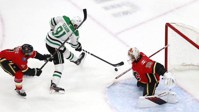 EDMONTON, ALBERTA - AUGUST 14: Cam Talbot #39 of the Calgary Flames stops a shot against Tyler Seguin #91 of the Dallas Stars as TJ Brodie #7 defends during the third period in Game Three of the Western Conference First Round during the 2020 NHL Stanley Cup Playoffs at Rogers Place on August 14, 2020 in Edmonton, Alberta, Canada.