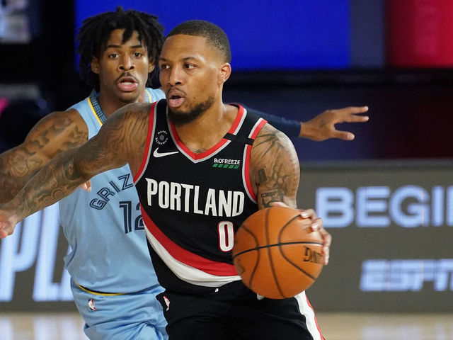 Damian Lillard drives by Ja Morant in the 2020 NBA play-in game