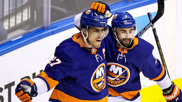 TORONTO, ONTARIO - AUGUST 16: Anders Lee #27 of the New York Islanders is congratulated by his teammate, Jordan Eberle #7 after scoring a goal at 14:50 against the Washington Capitals during the first period in Game Three of the Eastern Conference First Round during the 2020 NHL Stanley Cup Playoffs at Scotiabank Arena on August 16, 2020 in Toronto, Ontario.