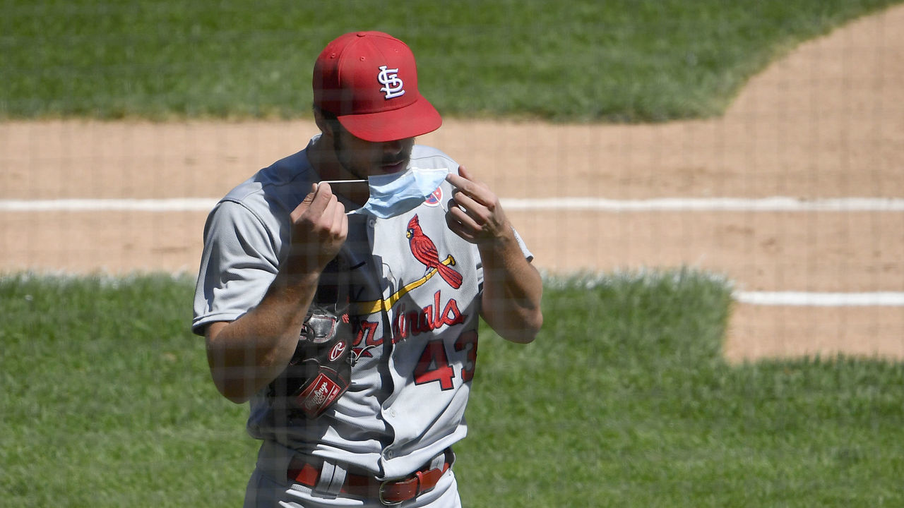CHICAGO, ILLINOIS - AUGUST 16: Starting pitcher Dakota Hudson #43 of the St. Louis Cardinals puts on a face mask before entering the dugout in the second inning against the Chicago White Sox at Guaranteed Rate Field on August 16, 2020 in Chicago, Illinois.