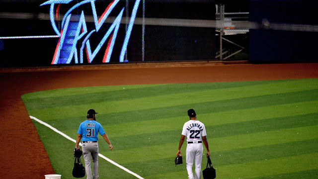 MIAMI, FLORIDA - JULY 09: Caleb Smith #31 and Sandy Alcantara #22 of the Miami Marlins head to the field to warm up before pitching in an intrasquad simulated game at Marlins Park on July 09, 2020 in Miami, Florida.