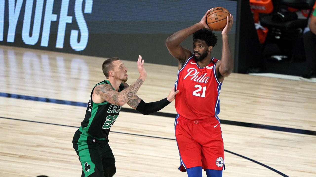 LAKE BUENA VISTA, FLORIDA - AUGUST 17: Joel Embiid #21 of the Philadelphia 76ers looks for a pass against Daniel Theis #27 of the Boston Celtics during the first half at The Field House at ESPN Wide World Of Sports Complex on August 17, 2020 in Lake Buena Vista, Florida.