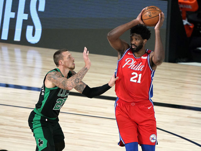 LAKE BUENA VISTA, FLORIDA - AUGUST 17: Joel Embiid #21 of the Philadelphia 76ers looks for a pass against Daniel Theis #27 of the Boston Celtics during the first half at The Field House at ESPN Wide World Of Sports Complex on August 17, 2020 in Lake Buena Vista, Florida.