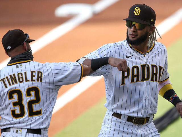 SAN DIEGO, CALIFORNIA - JULY 24: Manager Jayce Tingler and Fernando Tatis Jr. #23 of the San Diego Padres elbow bump as the starting lineups are announced prior to the Opening Day game against the Arizona Diamondbacks at PETCO Park on July 24, 2020 in San Diego, California.