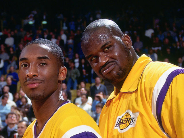 INGLEWOOD, CA - 1997: Kobe Bryant #8 and Shaquille O'Neal #32 of the Los Angeles Lakers pose during the National Anthem during a game circa 1997 at the Great Western Forum in Inglewood, California. Mandatory Copyright Notice: Copyright 1997 NBAE