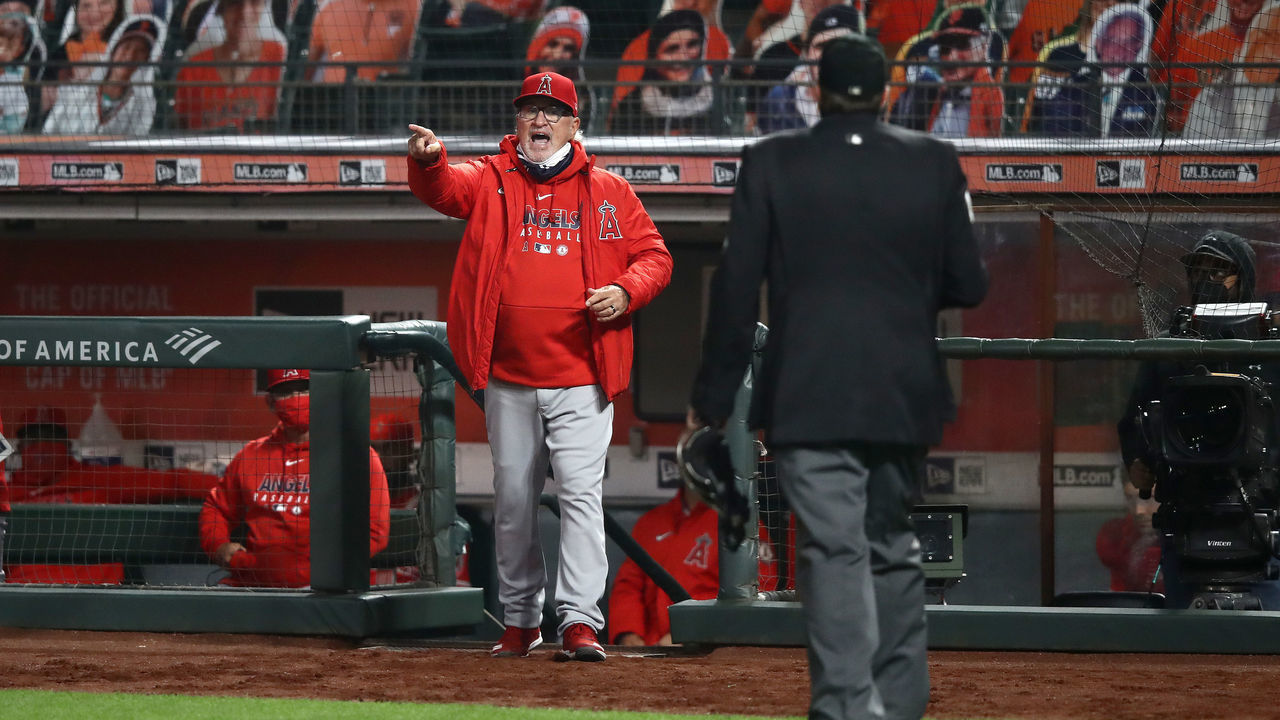SAN FRANCISCO, CALIFORNIA - AUGUST 20: Los Angeles Angels manager Joe Maddon talks with home plate umpire Lance Barrett in the seventh inning of their game against the San Francisco Giants at Oracle Park on August 20, 2020 in San Francisco, California.