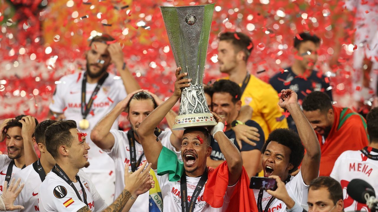 Sevilla's Brazilian midfielder Fernando (C) holds the trophy as Sevilla's players celebrate after winning the UEFA Europa League final football match Sevilla v Inter Milan on August 21, 2020, in Cologne, western Germany.