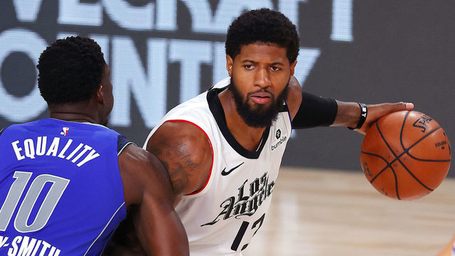 LAKE BUENA VISTA, FLORIDA - AUGUST 21: Paul George #13 of the LA Clippers looks to pass against Dorian Finney-Smith #10 of the Dallas Mavericks during the fourth quarter in Game Three of the Western Conference First Round during the 2020 NBA Playoffs at AdventHealth Arena at ESPN Wide World Of Sports Complex on August 21, 2020 in Lake Buena Vista, Florida.