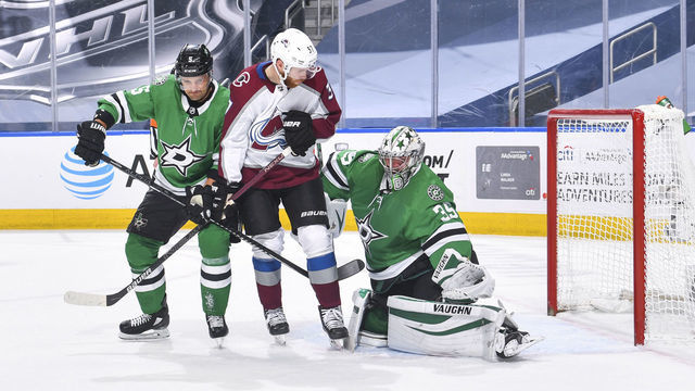 EDMONTON, ALBERTA - AUGUST 05: Anton Khudobin #35 of the Dallas Stars makes a glove save as Andrej Sekera #5 defends against J.T. Compher #37 of the Colorado Avalanche during the second period of a Western Conference Round Robin game during the 2020 NHL Stanley Cup Playoff at Rogers Place on August 05, 2020 in Edmonton, Alberta.