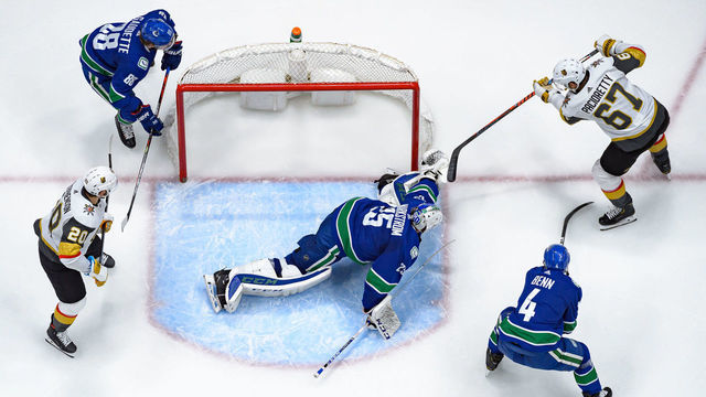 VANCOUVER, BC - DECEMBER 19: Vancouver Canucks Goaltender Jacob Markstrom (25) makes a save on Vegas Golden Knights Left Wing Max Pacioretty (67) during their NHL game at Rogers Arena on December 19, 2019 in Vancouver, British Columbia, Canada.