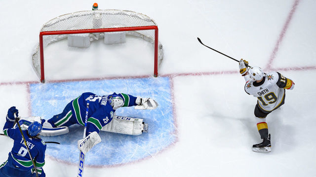 VANCOUVER, BC - DECEMBER 19: Vegas Golden Knights Right Wing Reilly Smith (19) scores a goal on Vancouver Canucks Goaltender Jacob Markstrom (25) during their NHL game at Rogers Arena on December 19, 2019 in Vancouver, British Columbia, Canada.