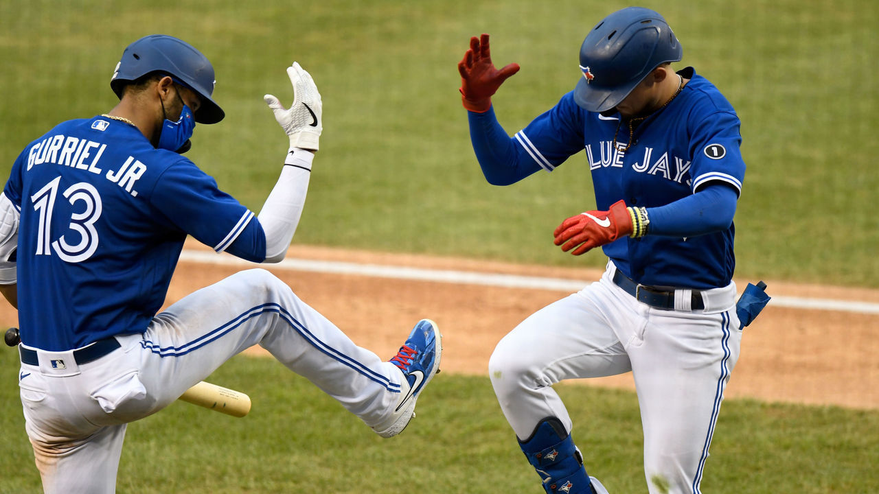 WASHINGTON, DC - JULY 30: Cavan Biggio #8 of the Toronto Blue Jays celebrates with Lourdes Gurriel Jr. #13 after hitting a home run in the seventh inning against the Washington Nationals at Nationals Park on July 30, 2020 in Washington, DC, United States. The Blue Jays played as the home team due to their stadium situation and the Canadian governmentÕs policy on COVID-19.