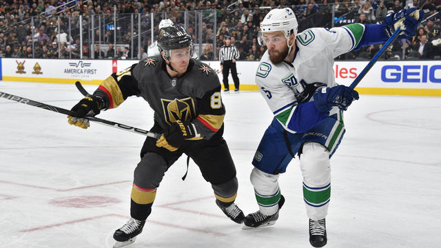 LAS VEGAS, NEVADA - DECEMBER 15: Jonathan Marchessault #81 of the Vegas Golden Knights battles Oscar Fantenberg #5 of the Vancouver Canucks during the first period at T-Mobile Arena on December 15, 2019 in Las Vegas, Nevada.
