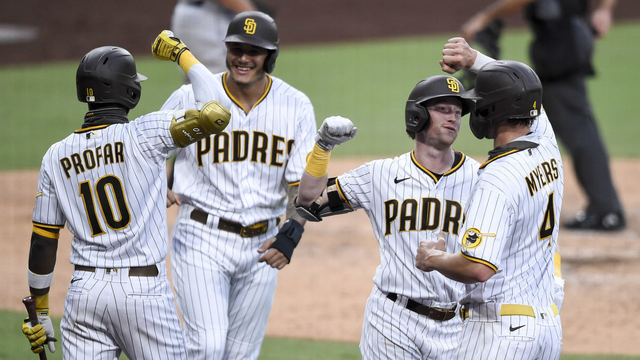 SAN DIEGO, CA - AUGUST 22: Jake Cronenworth #9 of the San Diego Padres is congratulated by Wil Myers #4 after hitting a grand slam as Jurickson Profar #10 and Manny Machado #13 celebrate during the second inning of a baseball game against the Houston Astros at Petco Park on August 22, 2020 in San Diego, California.