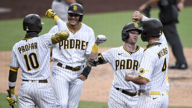 SAN DIEGO, CA - AUGUST 22: Jake Cronenworth #9 of the San Diego Padres is congratulated by Wil Myers #4 after hitting a grand slam as Jurickson Profar #10 and Manny Machado #13 celebrate during the second inning of a baseball game against the Houston Astros at Petco Park on August 22, 2020 in San Diego, California.