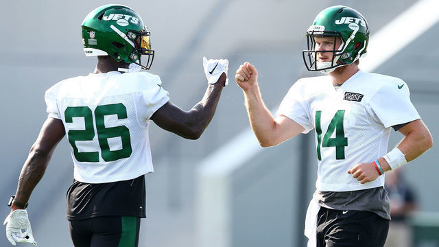 FLORHAM PARK, NEW JERSEY - AUGUST 14: Sam Darnold #14 and Le'Veon Bell #26 of the New York Jets fist bump at Atlantic Health Jets Training Center on August 14, 2020 in Florham Park, New Jersey.