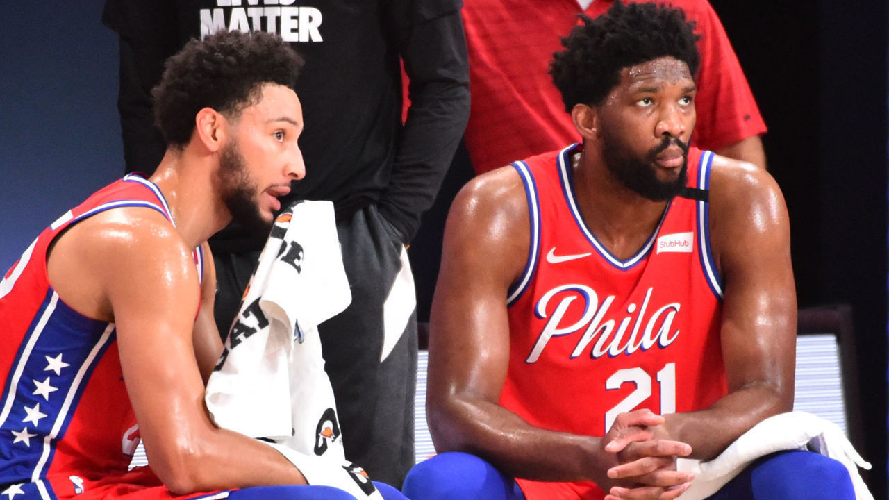 Orlando, FL - AUGUST 5: Ben Simmons #25 of the Philadelphia 76ers and Joel Embiid #21 of the Philadelphia 76ers look on during a game against the Washington Wizards on August 5, 2020 at The Arena at ESPN Wide World of Sports in Orlando, Florida. NOTE TO USER: User expressly acknowledges and agrees that, by downloading and/or using this Photograph, user is consenting to the terms and conditions of the Getty Images License Agreement. Mandatory Copyright Notice: Copyright 2020 NBAE