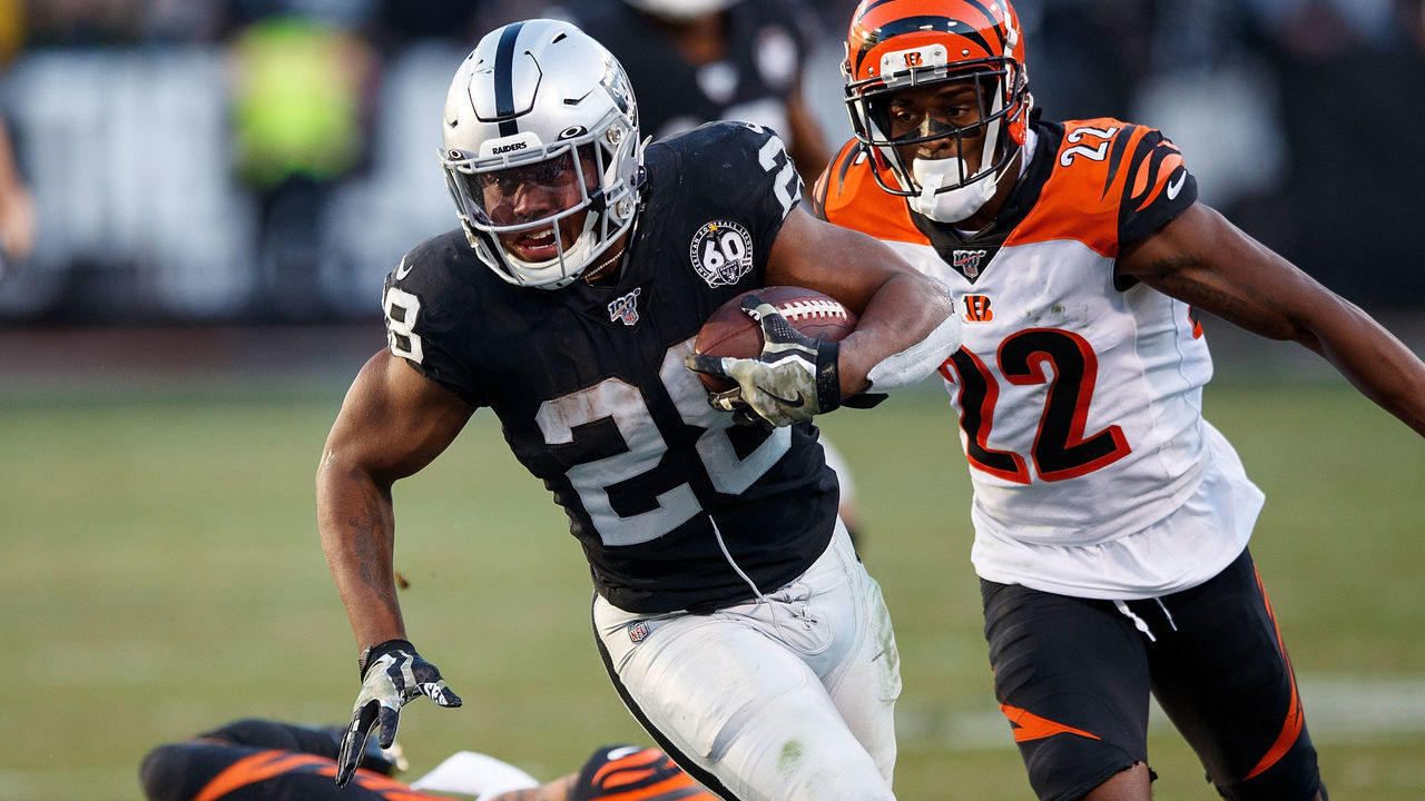OAKLAND, CA - NOVEMBER 17: Running back Josh Jacobs #28 of the Oakland Raiders rushes past free safety Jessie Bates #30 of the Cincinnati Bengals and cornerback William Jackson #22 during the fourth quarter at RingCentral Coliseum on November 17, 2019 in Oakland, California. The Oakland Raiders defeated the Cincinnati Bengals 17-10.